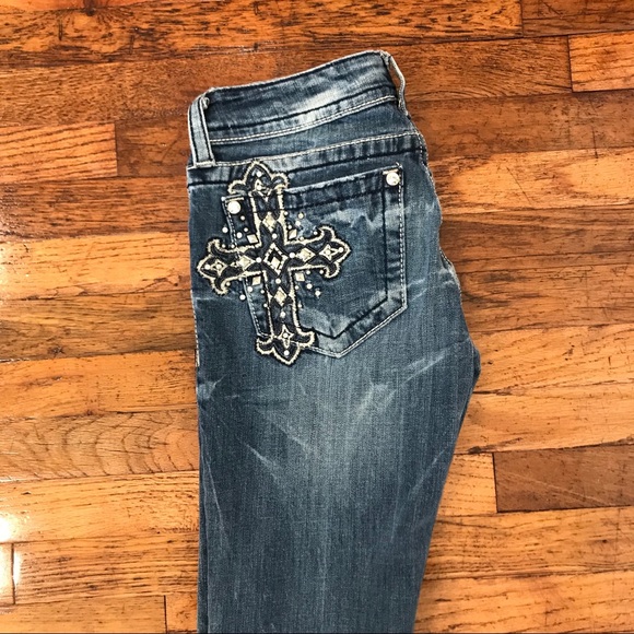 designer jeans with cross on back pocket